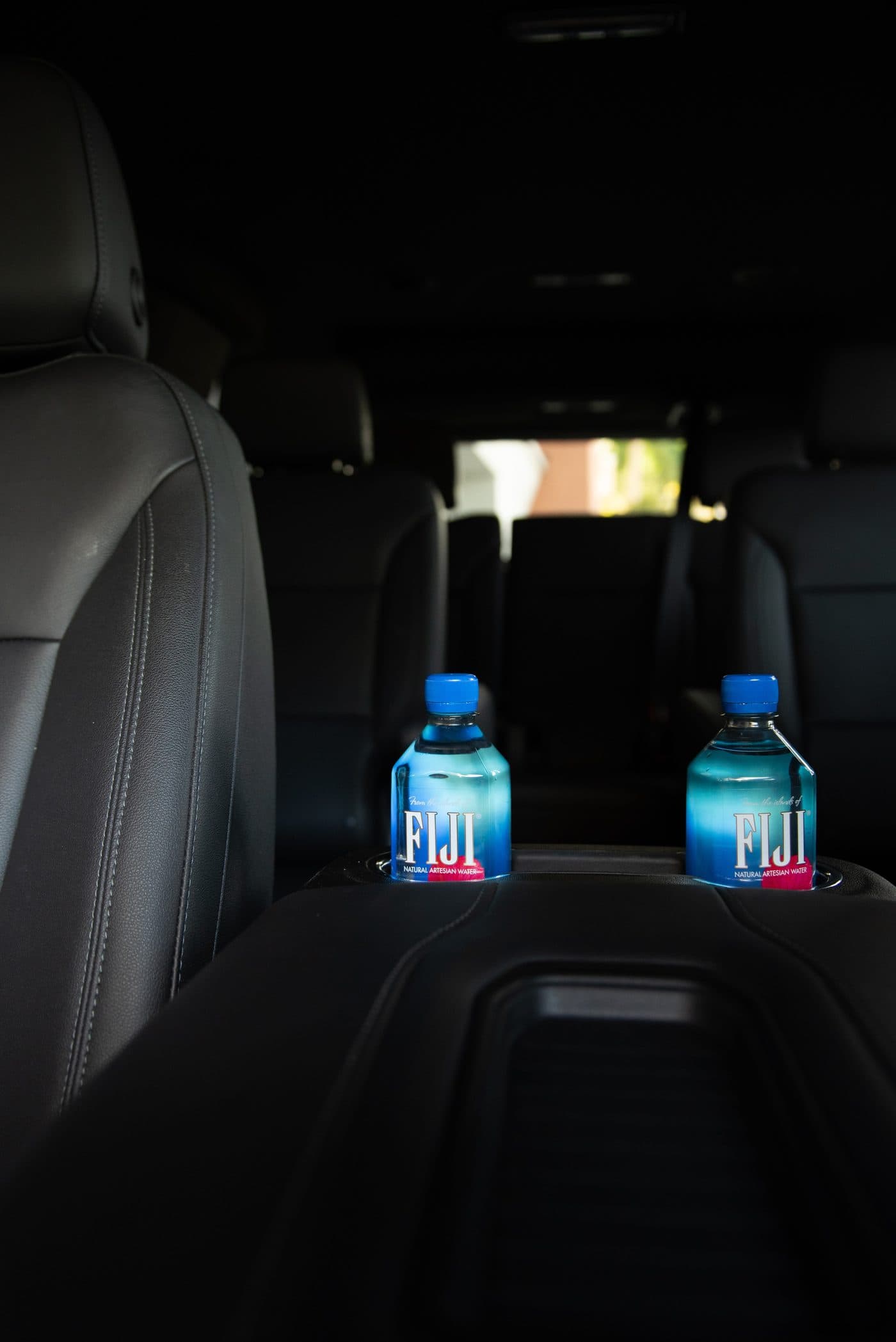 Suburban interior with chilled FIJI water bottles